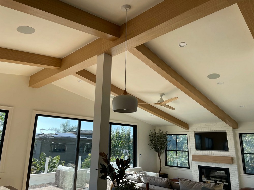 In-ceiling speakers installed along exposed wood beams, whole-home audio installation