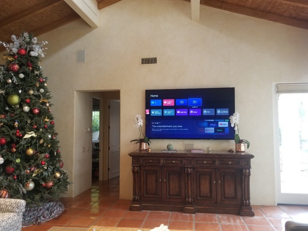Wall-mounted TV with soundbar, home theater installation